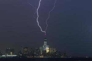 New York City, New York State, USA --- Two bolts of lightning hit the antenna on top of One World Trade Center in Lower Manhattan as an electrical storm moves over New York, May 23, 2014. --- Image by © Gary Hershorn/Corbis